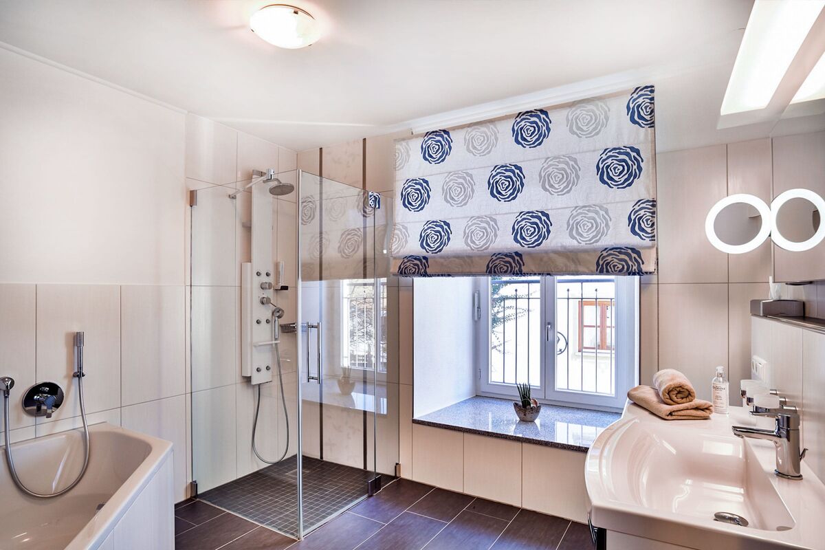 Badezimmer mit Badewanne und Dusche